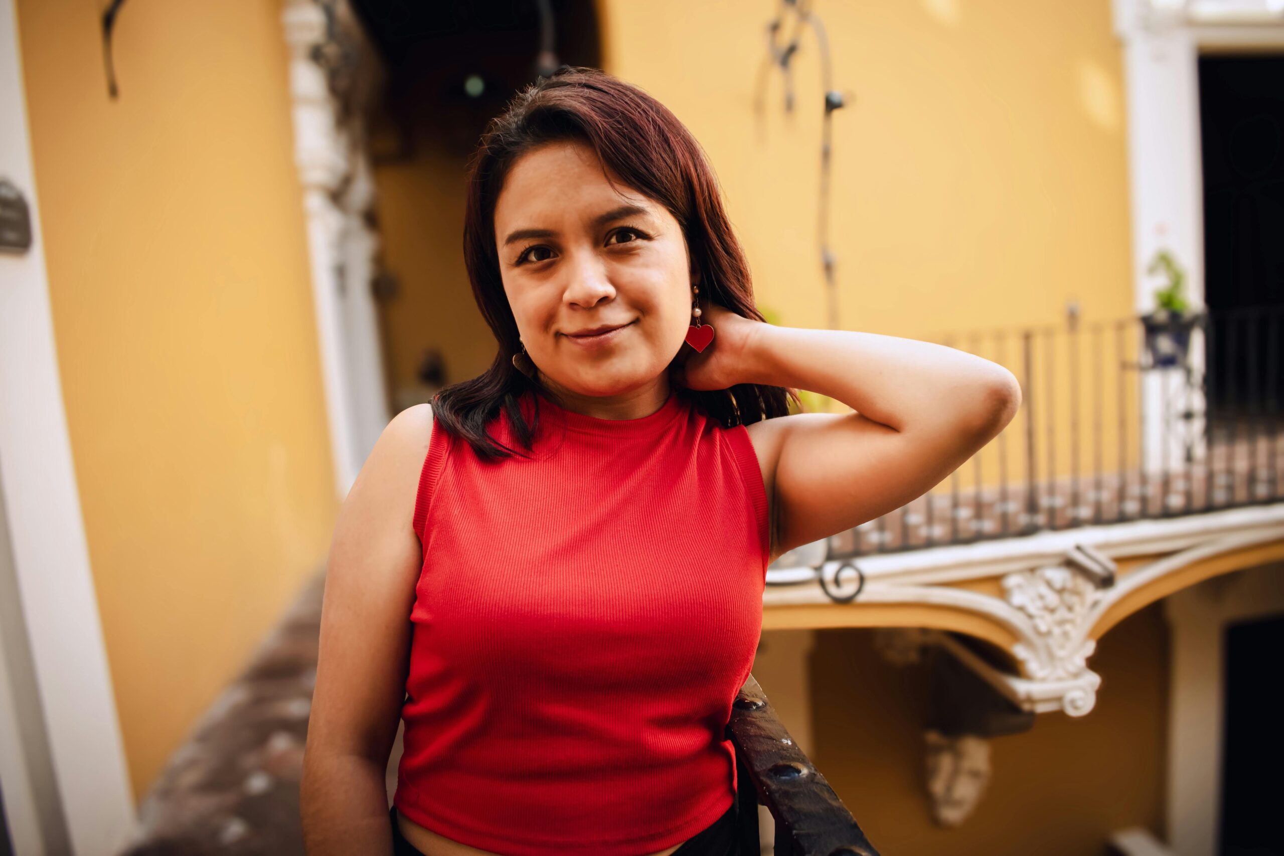 Home Charming portrait of a woman in a red top in Puebla, Mexico